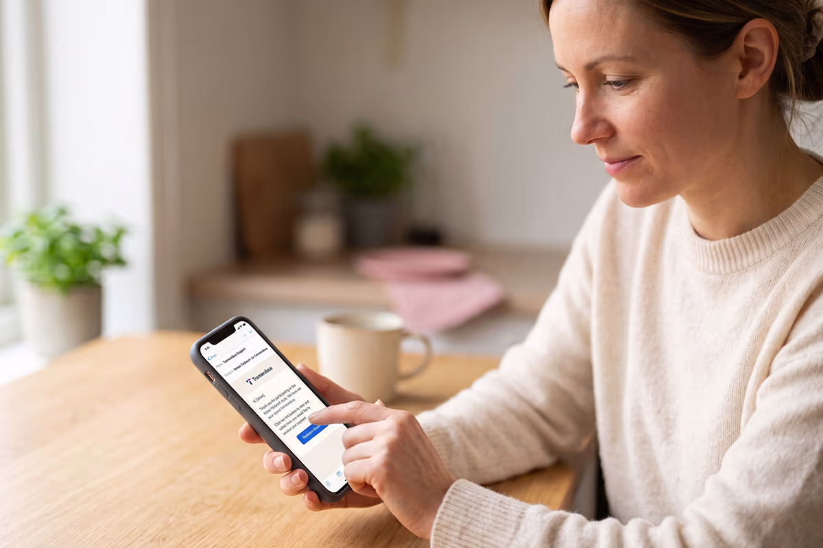 woman-using-phone-tremendous-app